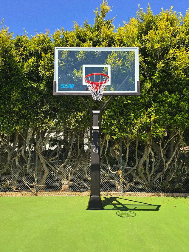 SOAR basketball hoop on an outdoor court surrounded by trees