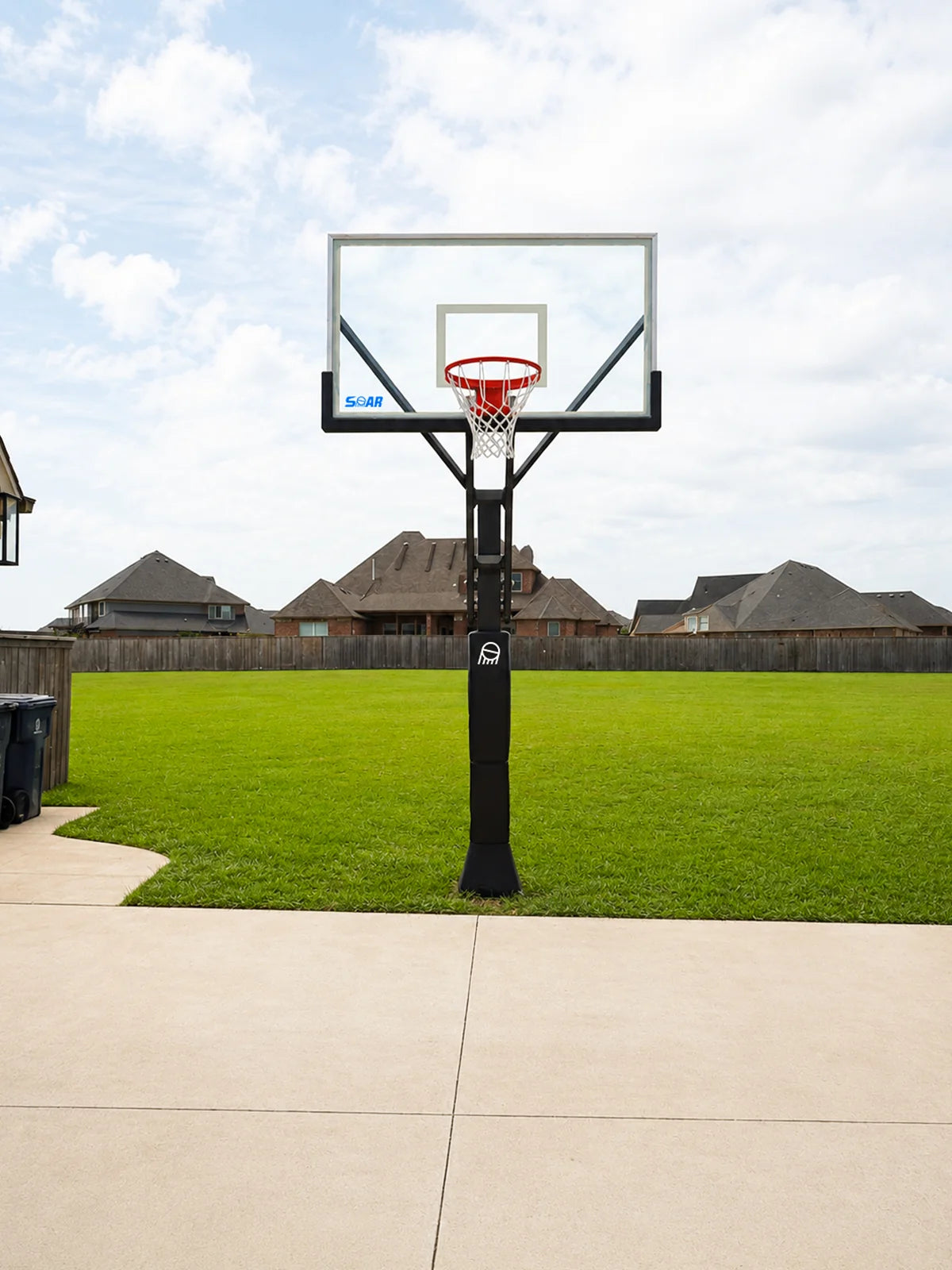 SOAR basketball hoop beside a driveway and open lawn